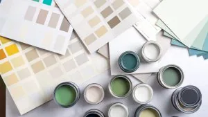 Paint cans and color swatches arranged for a residential paint project